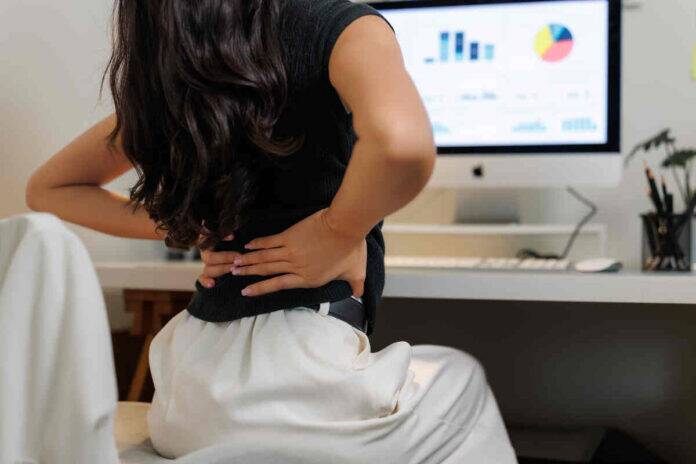 How does workplace stress strain your spine and cause back pain?
