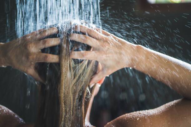 What happens if a person washes hair with hot water?
