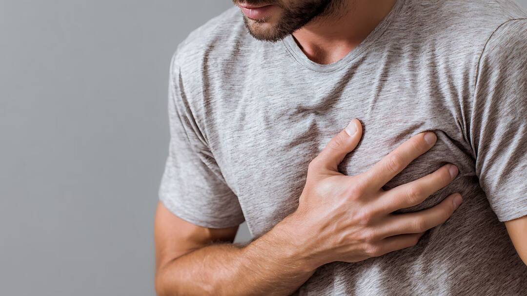 Why do some people suffer sudden cardiac arrests during vacations?