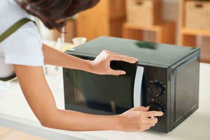 Is standing near microwave while it heats food safe?